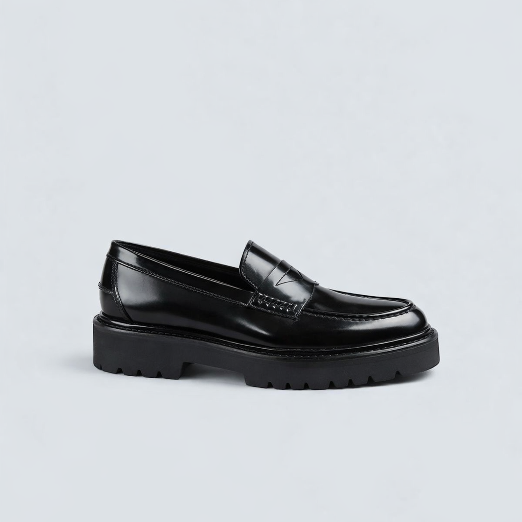 Black loafers on a light gray background