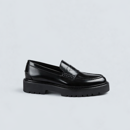 Black loafers on a light gray background
